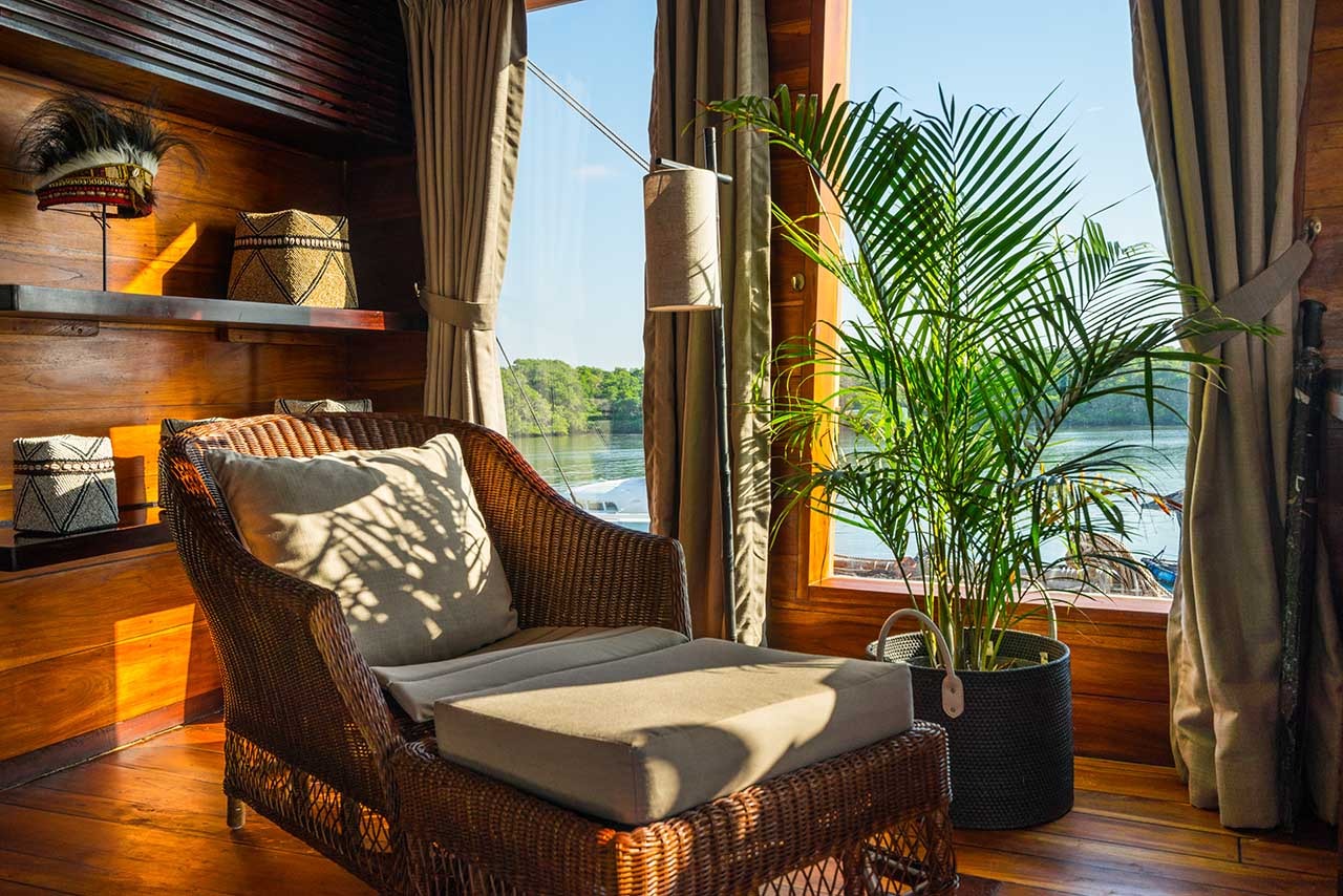Cosy reading nook on Prana by Atzaró with rattan chair, tribal accents and mangrove views
