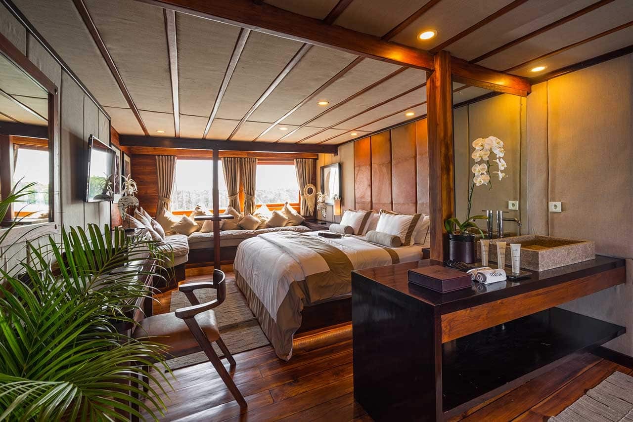 Warmly lit Prana by Atzaró cabin with king bed, daybed and orchids
