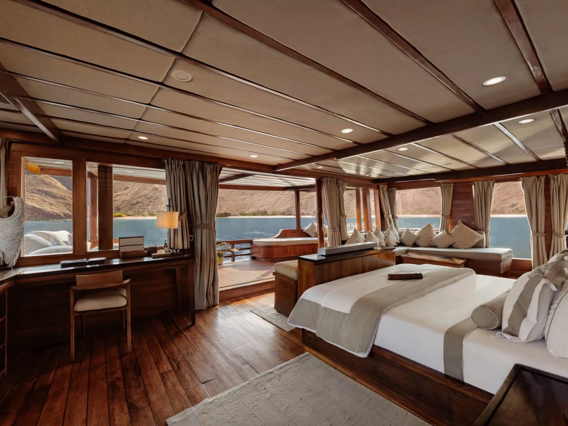 Prana by Atzaró ocean-view suite with wraparound windows over Komodo waters