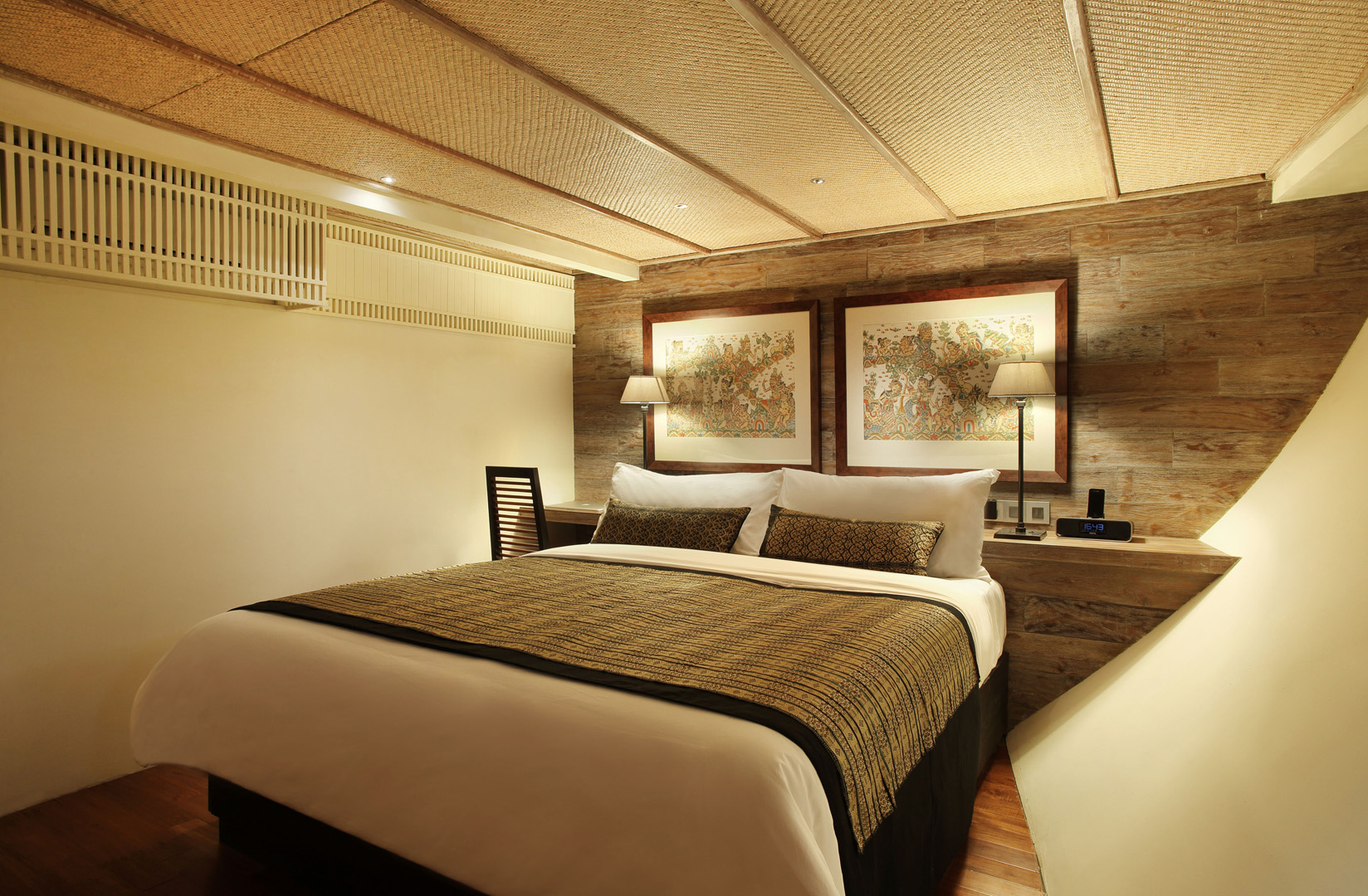 Bali Suite on Alila Purnama with king bed and framed Balinese classical paintings