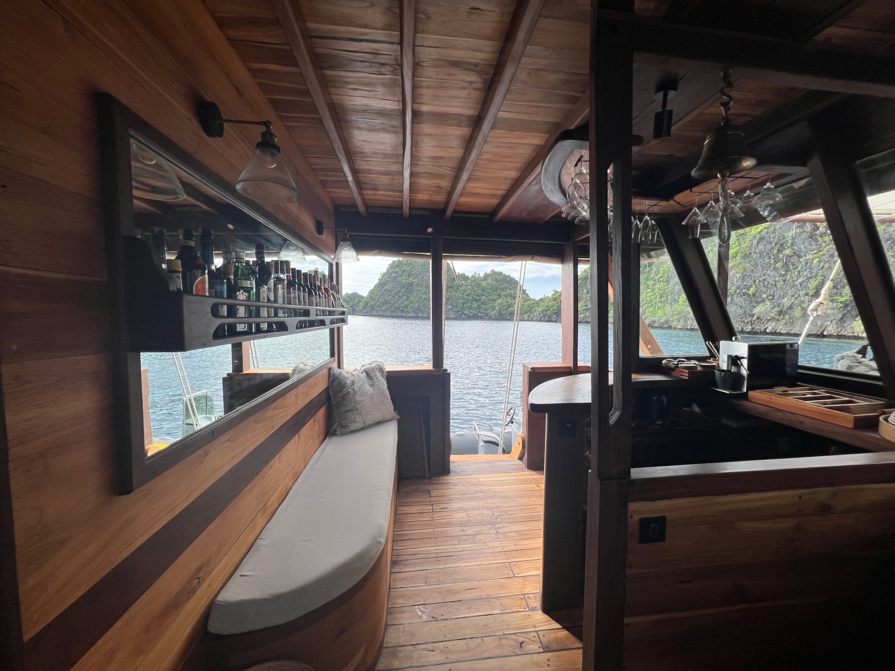 Dewata bar lounge with cushioned banquette and karst island framed in the window