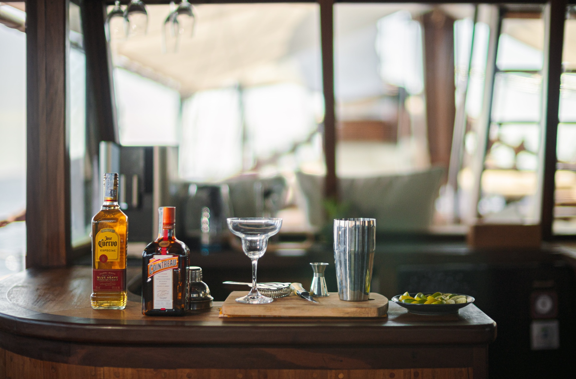 Barman's station on Nataraja with tequila, Cointreau, shaker and margarita coupe on a wooden bar